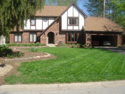 Front yard in May after slice seeding — full green lawn